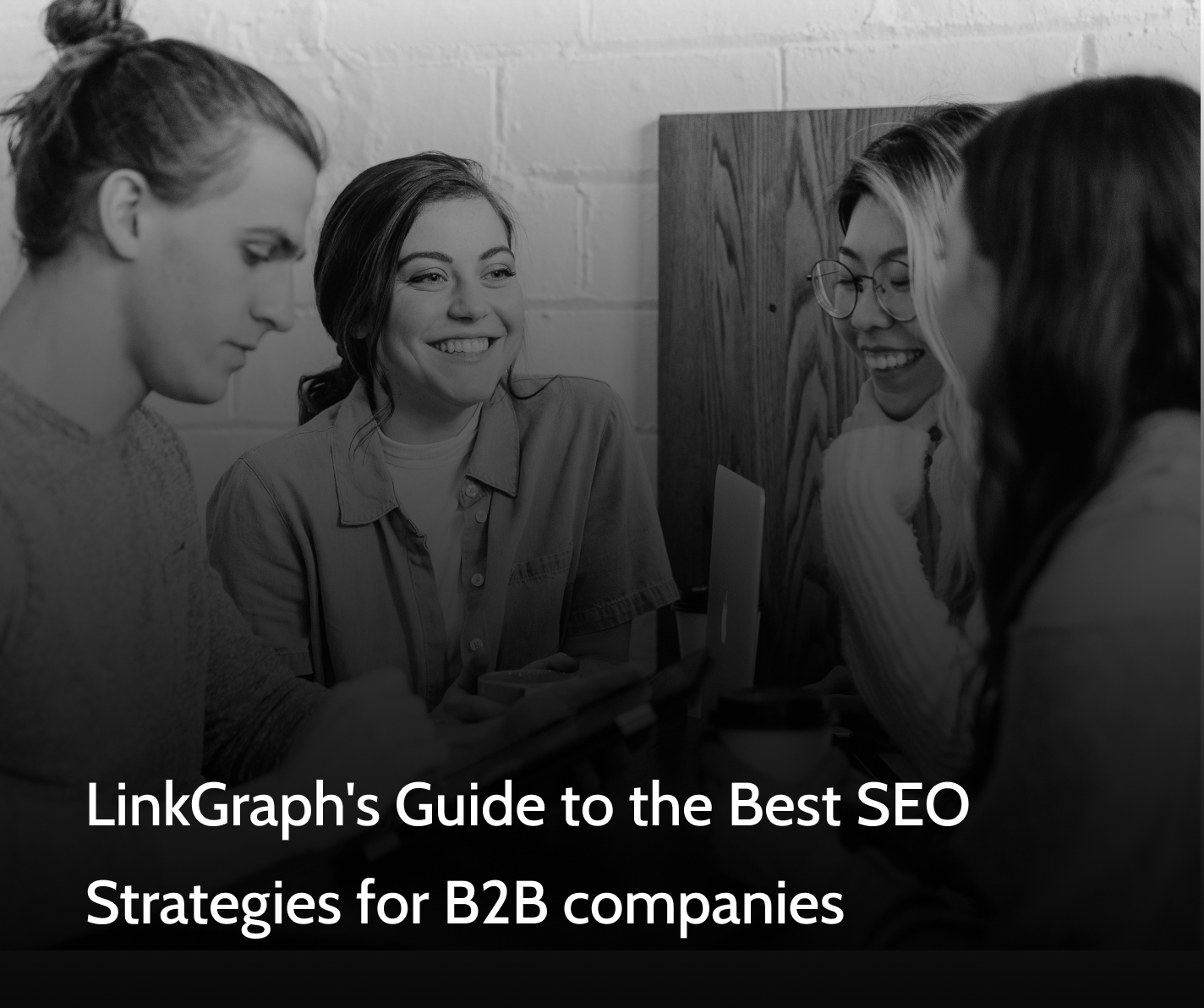 LinkGraph's Guide to the Best SEO Strategies for B2B companies in text with a group of people sitting around a conference table