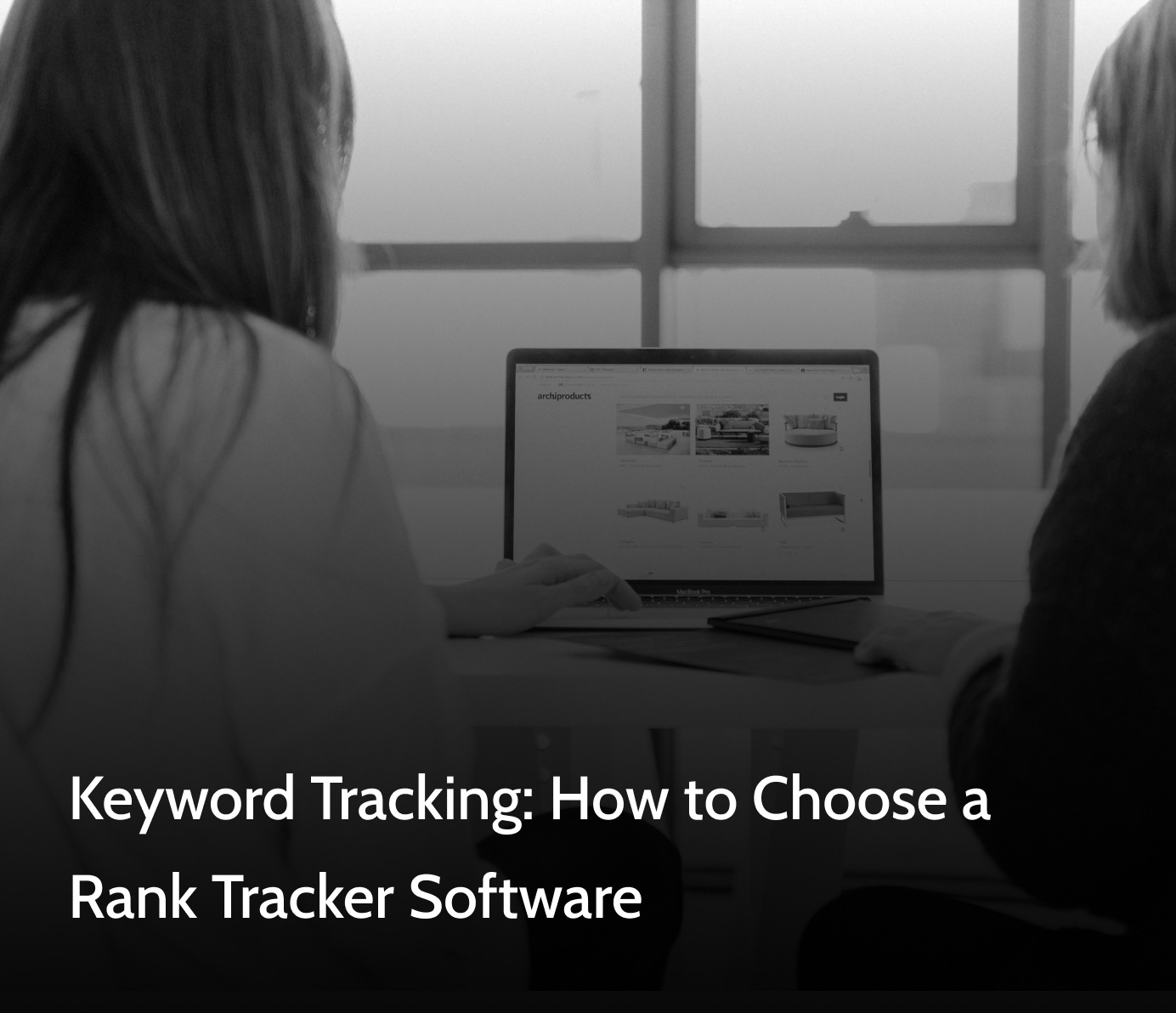 Two people looking at a keyword tracking software