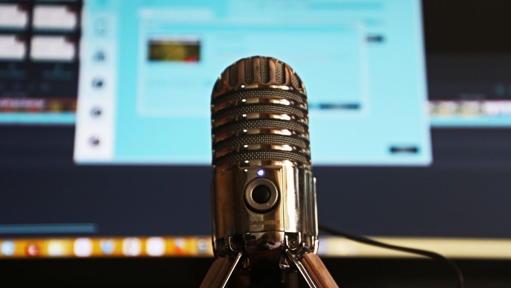microphone in foreground with computer screen in background