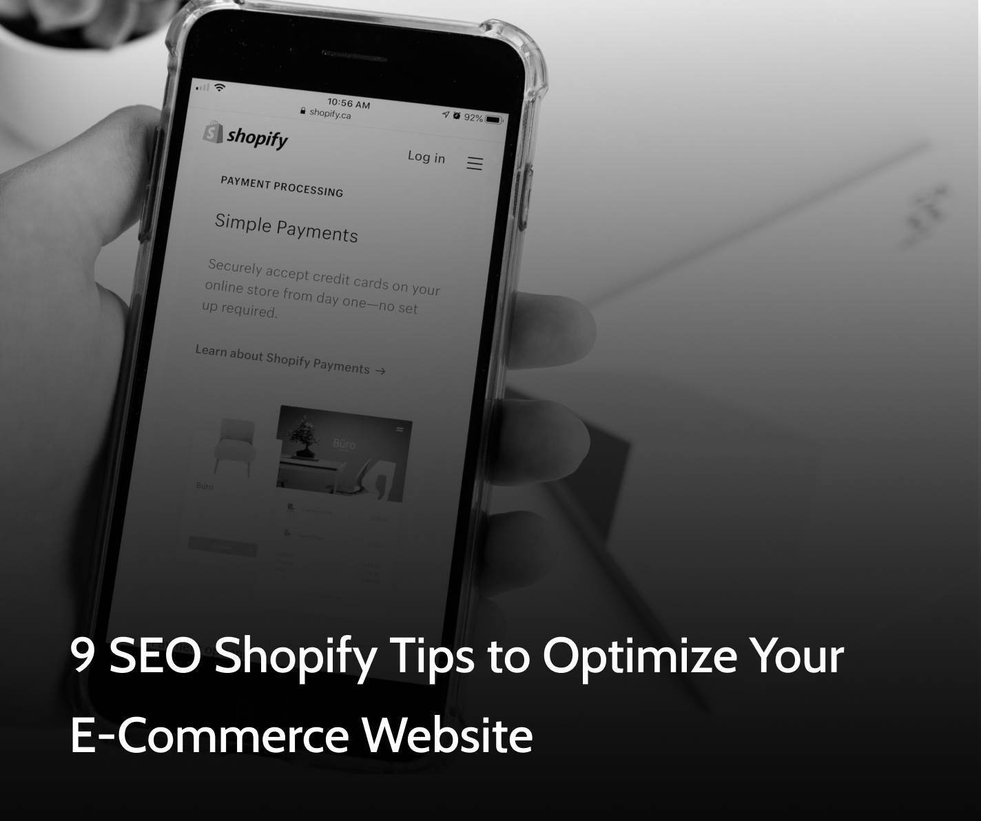Site owner holding phone and reading through SEO Shopify tips